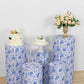 White and blue spandex pedestal stand covers with floral pattern.