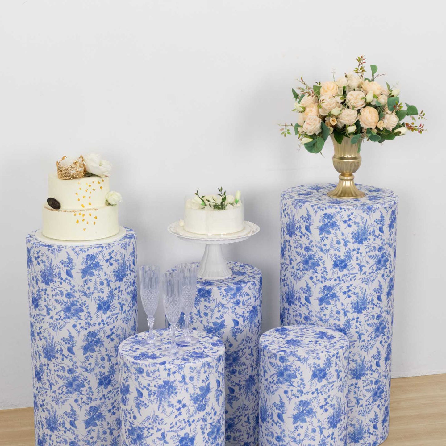 White and blue spandex pedestal stand covers with floral pattern.