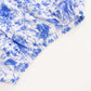 White and blue spandex pedestal stand cover in floral pattern.