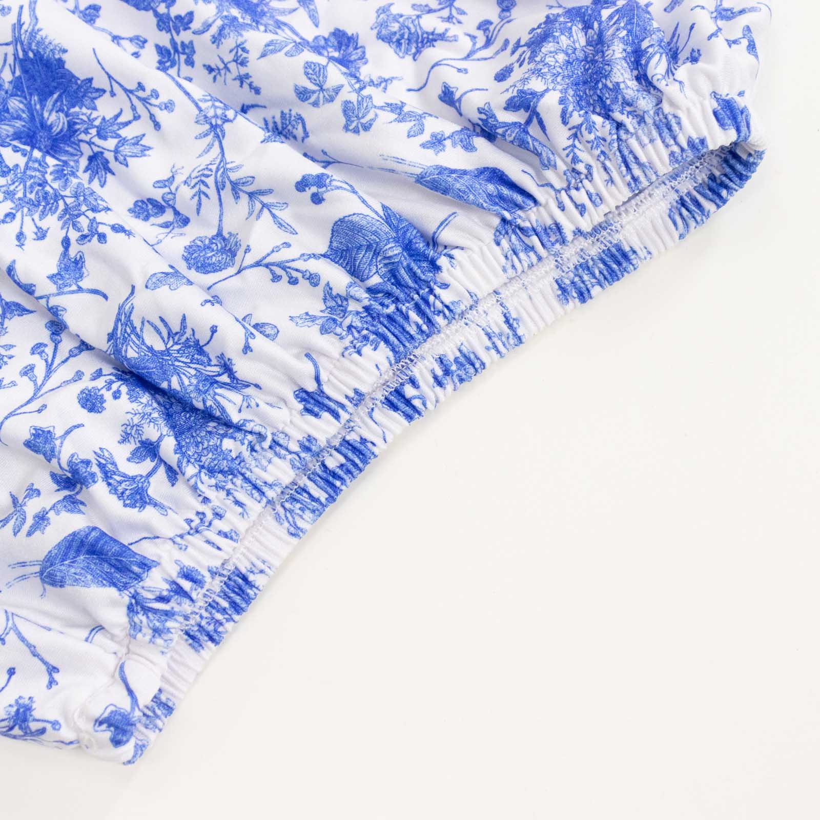 White and blue spandex pedestal stand cover in floral pattern.