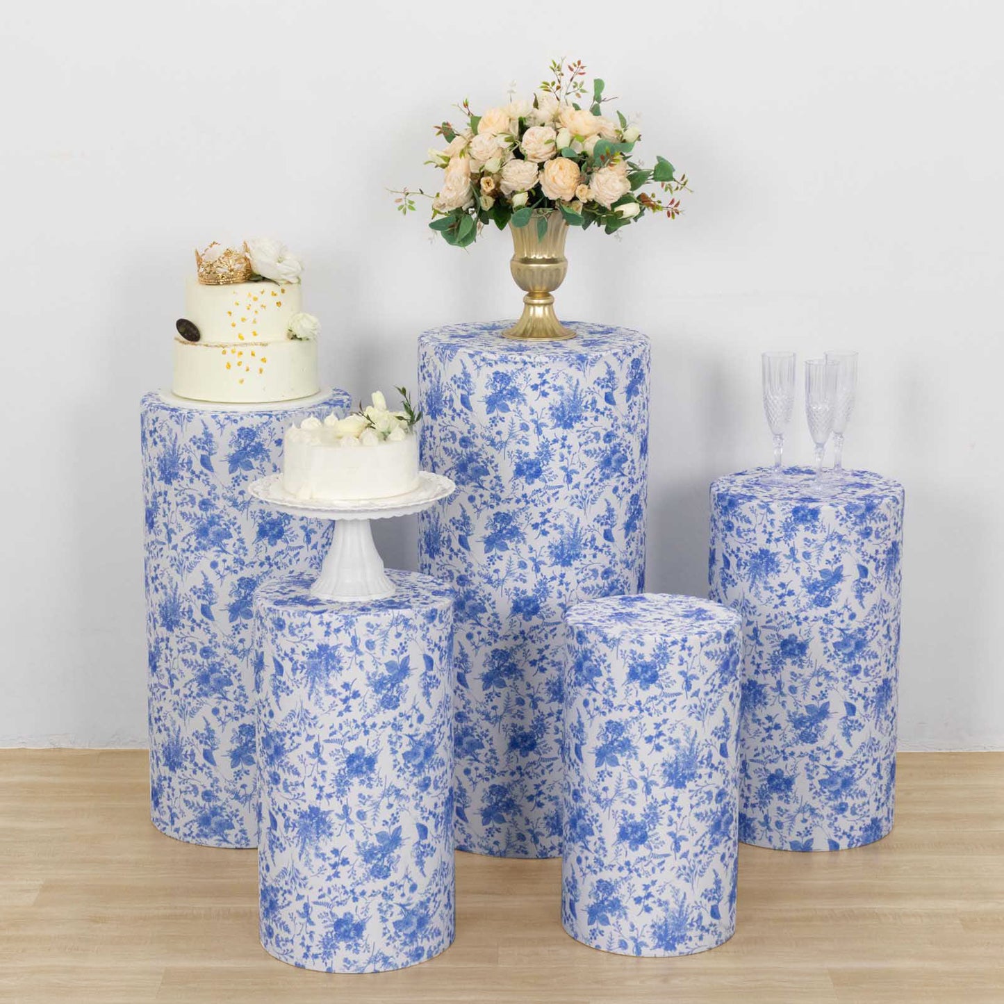White and blue spandex pedestal stand covers with floral pattern.
