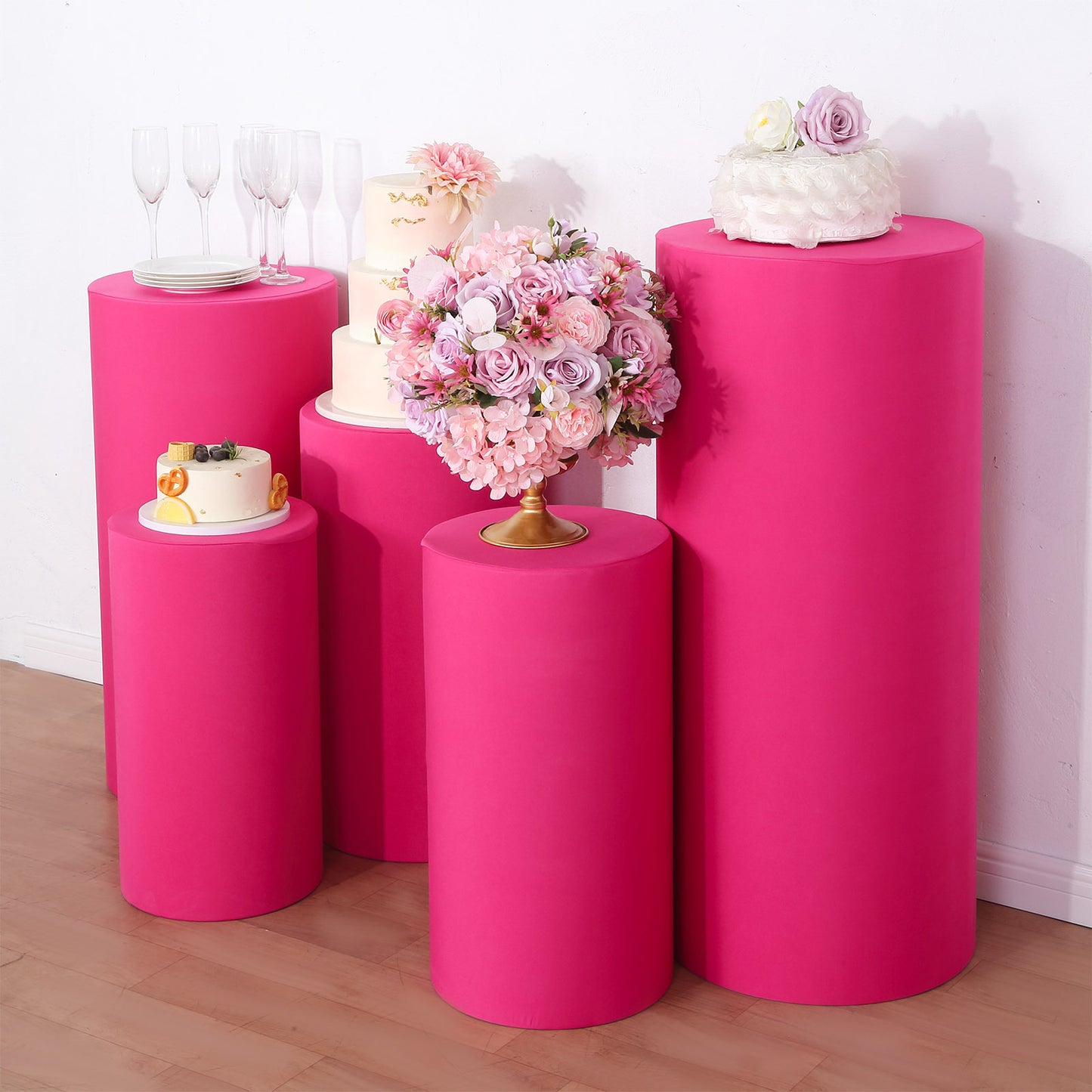 Fuchsia spandex pedestal stand covers in a set of 5.