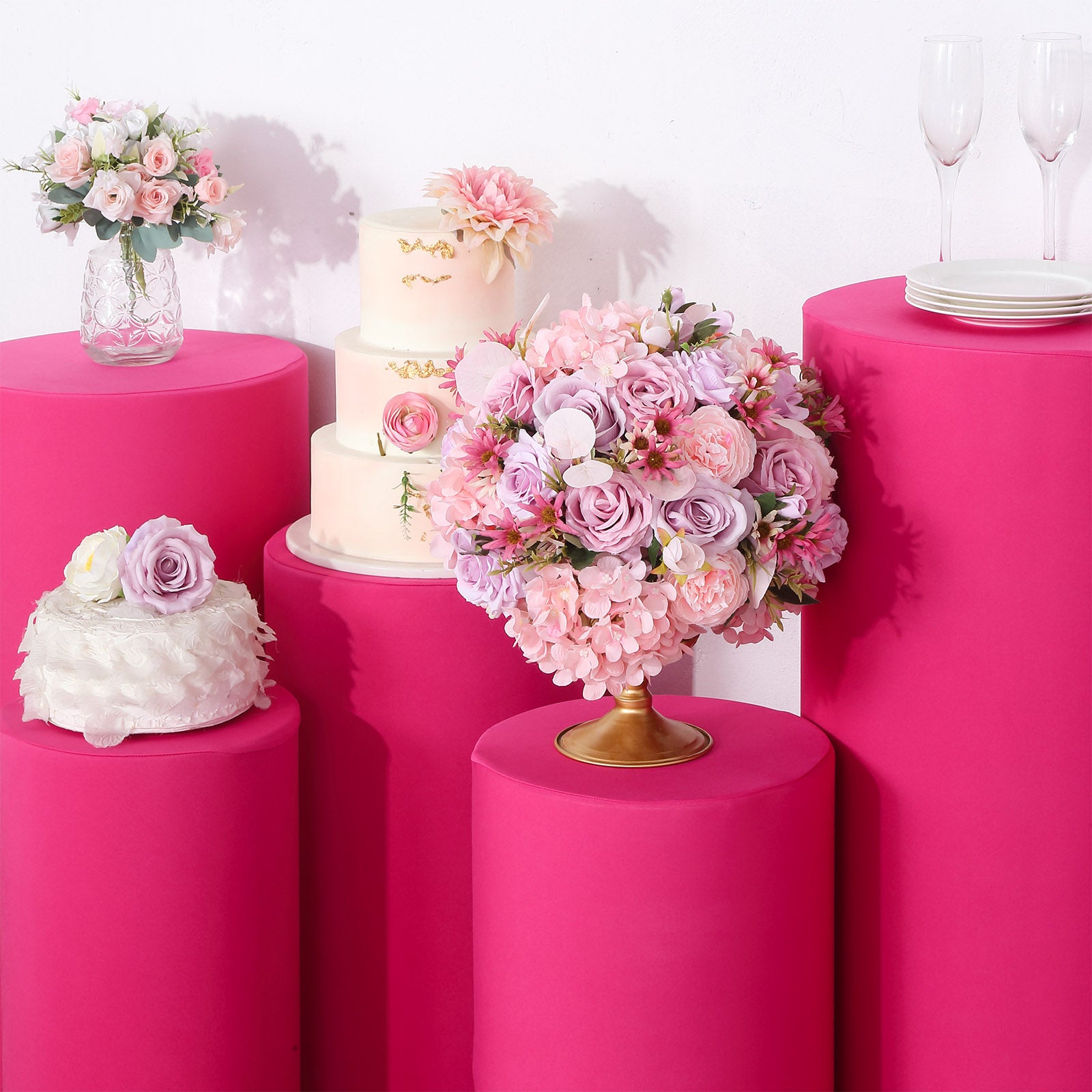 Fuchsia spandex pedestal stand covers for events and decorations.