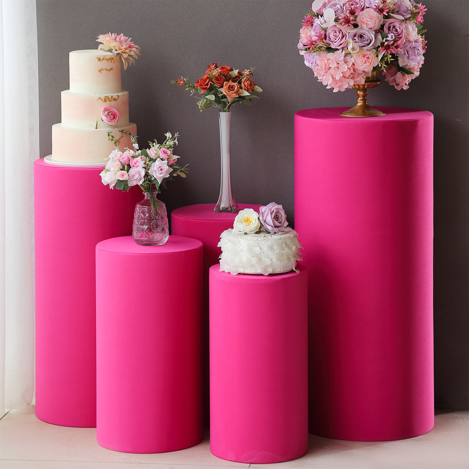 Fuchsia spandex pedestal stand covers for events and decorations.