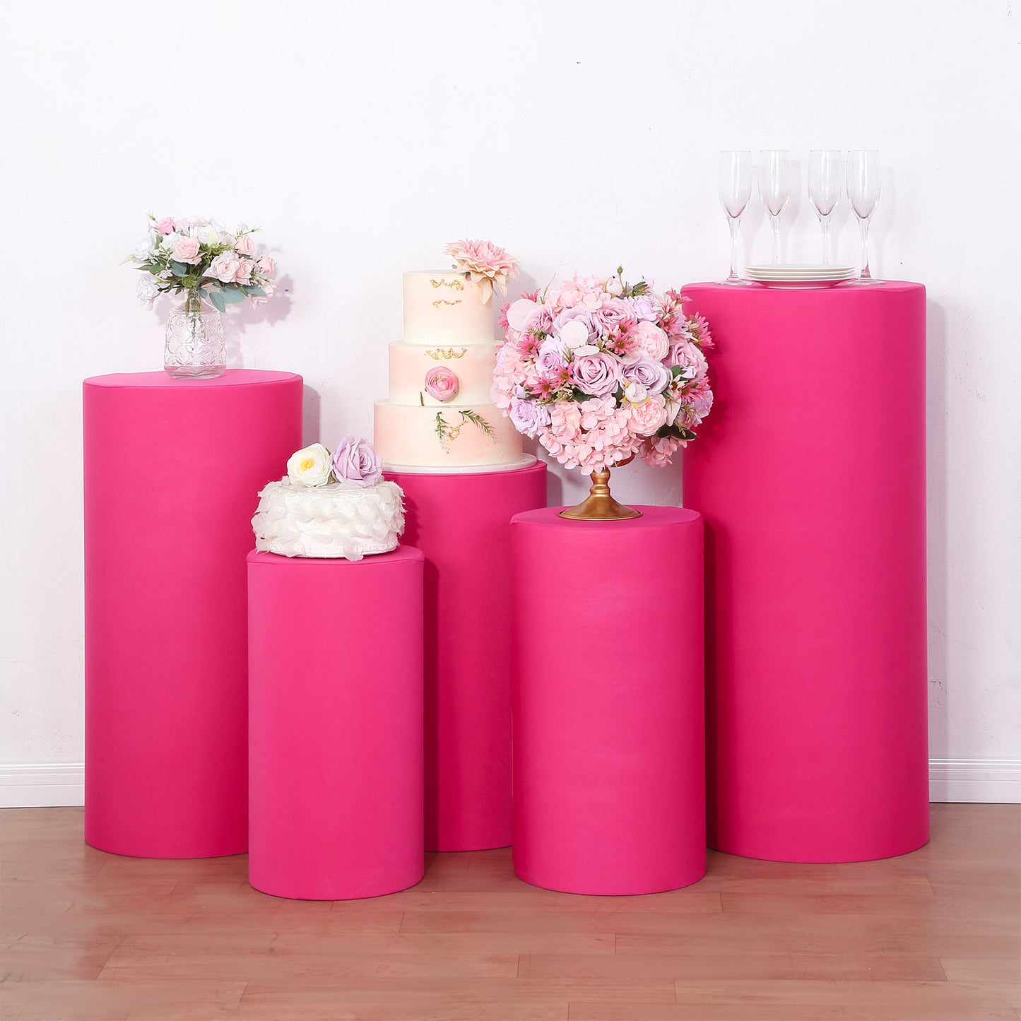 Fuchsia spandex pedestal stand covers for events and displays.
