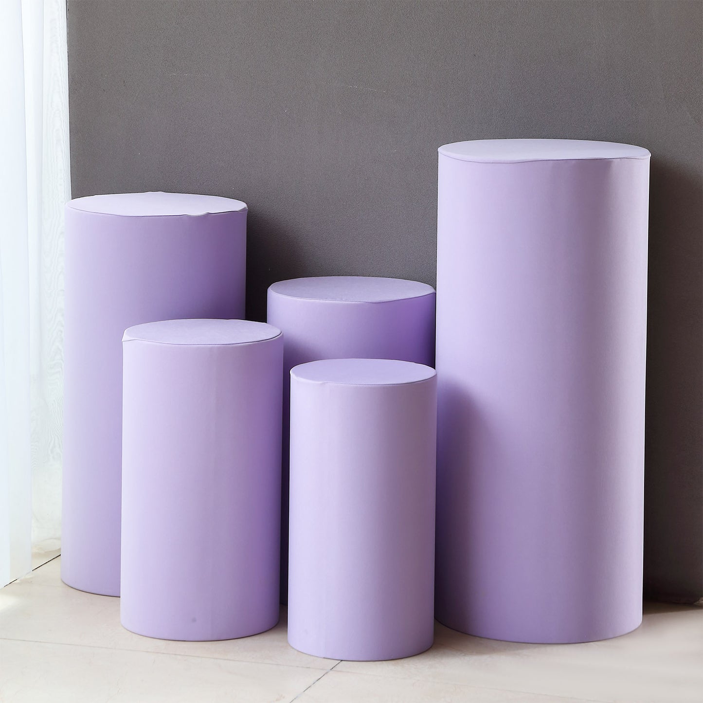 Set of 5 lavender spandex pedestal stand covers in various sizes.