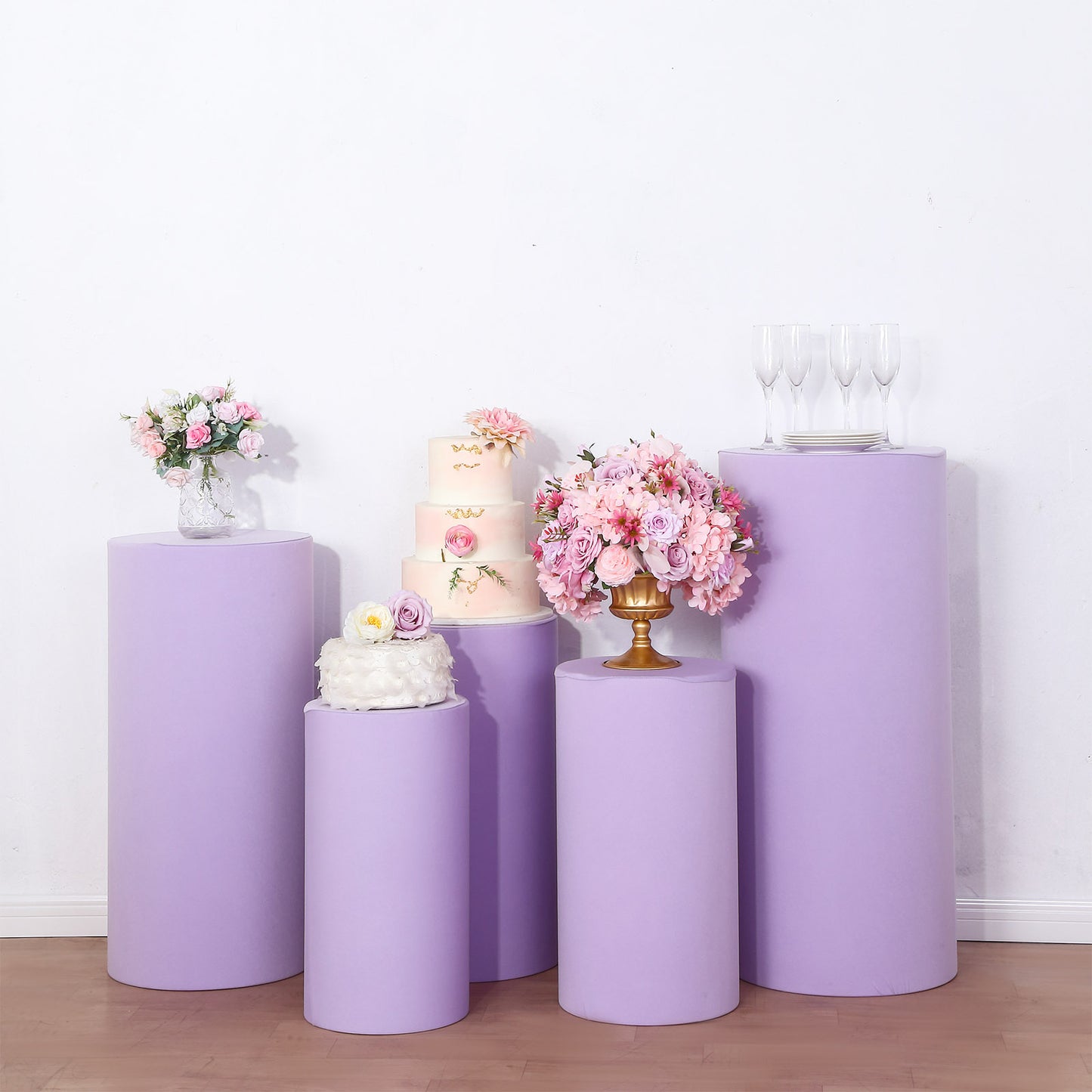 Lavender cylinder pedestal stand covers for events and displays.