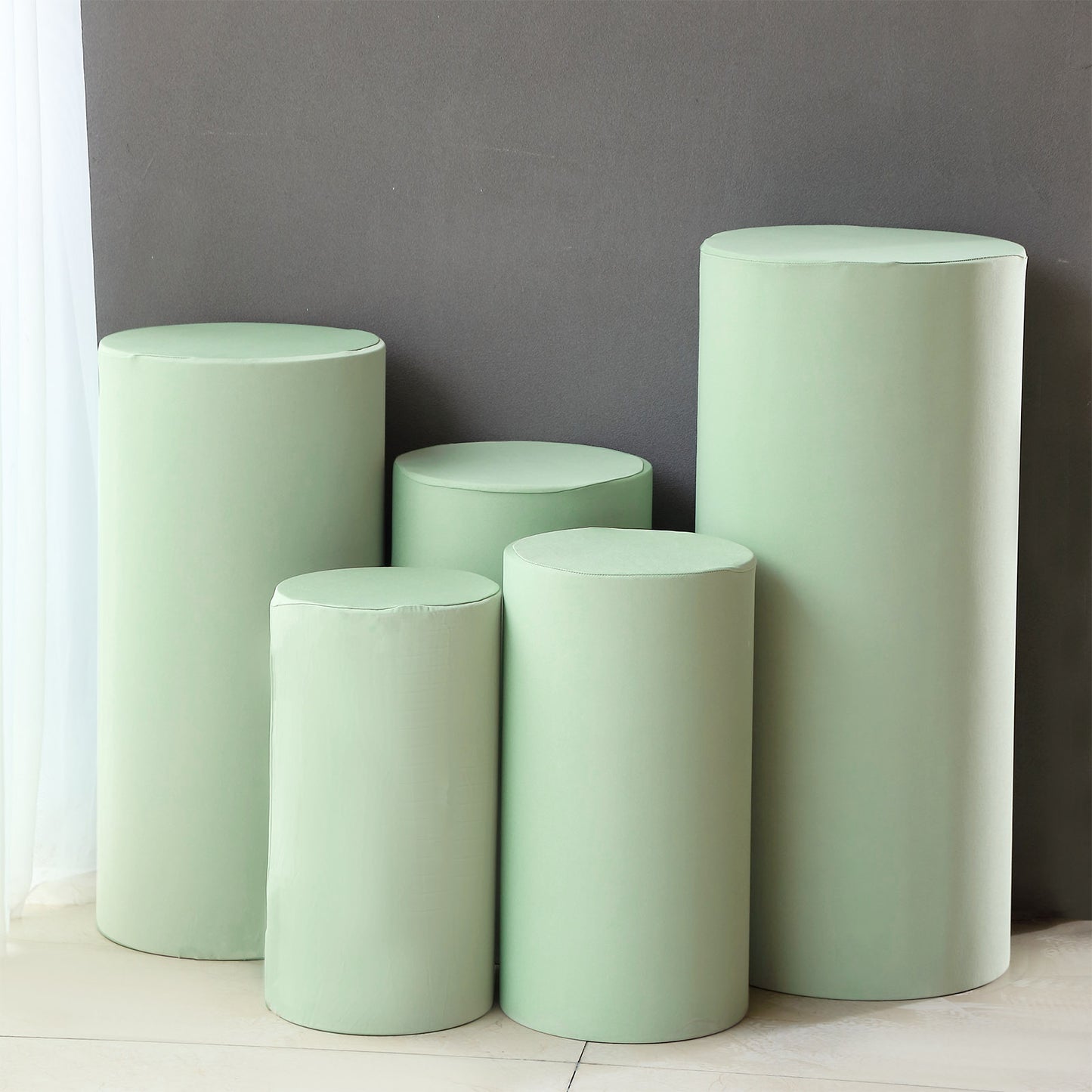 Set of 5 sage green spandex pedestal stand covers.