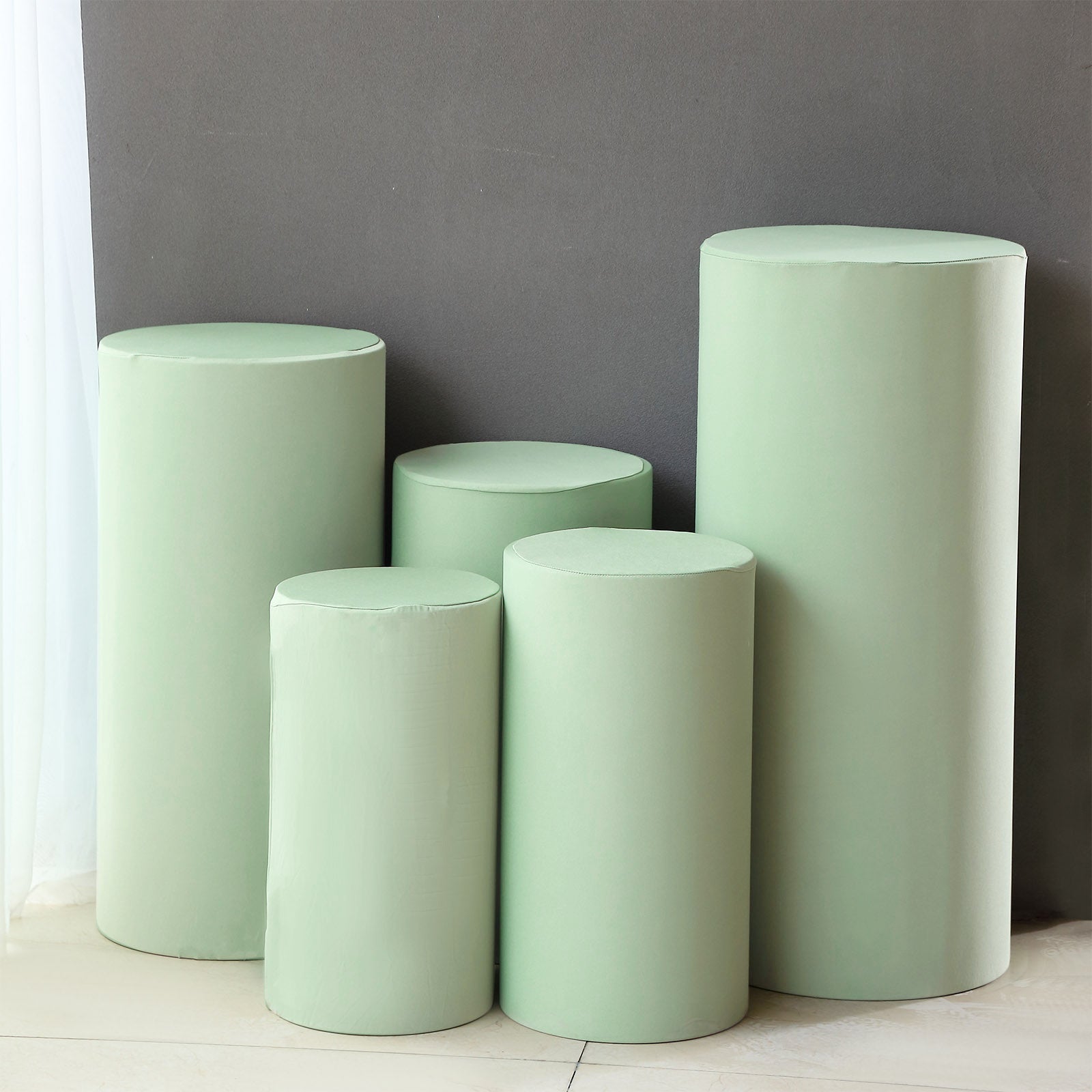 Set of 5 sage green spandex pedestal stand covers.