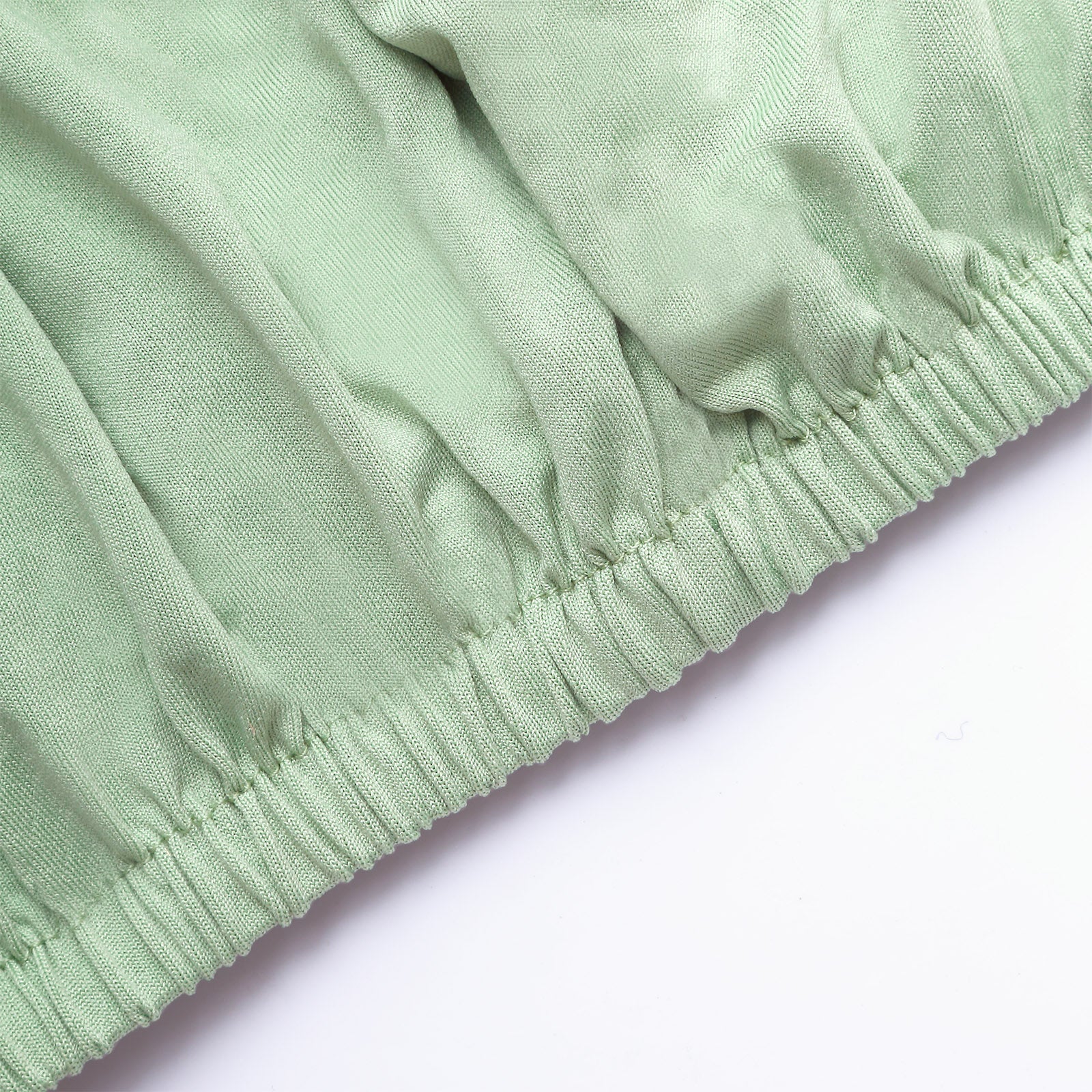 Sage green spandex pedestal stand cover with stretchable fabric.