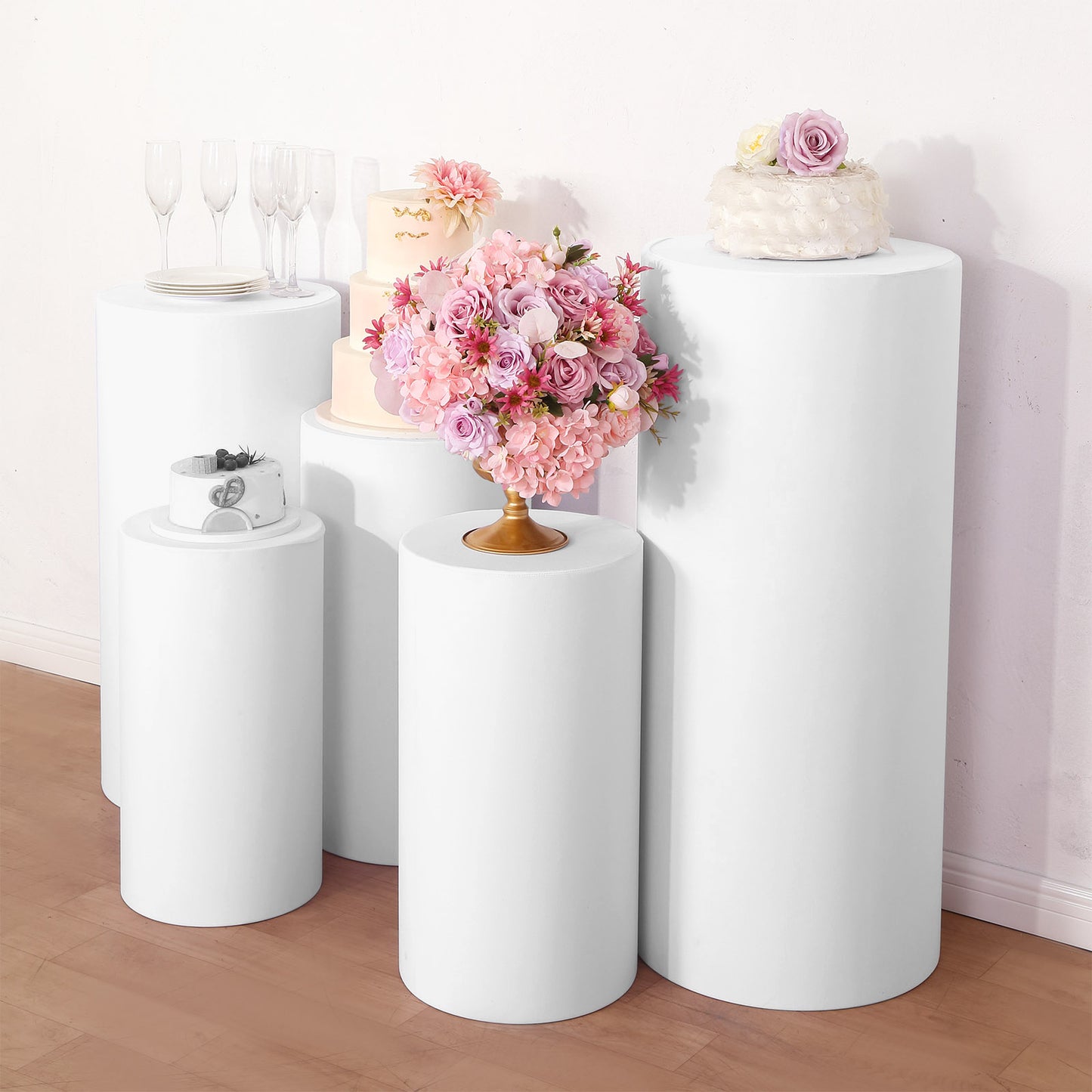 White spandex pedestal stand covers for events and displays.