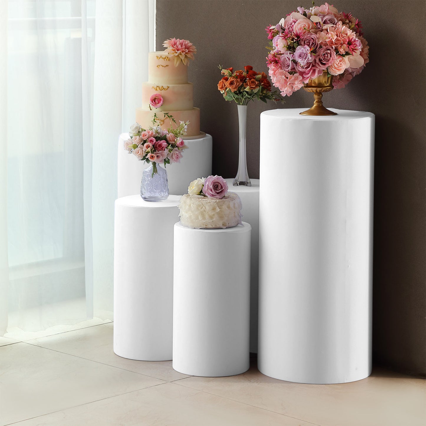 White spandex pedestal stand covers for events and displays.