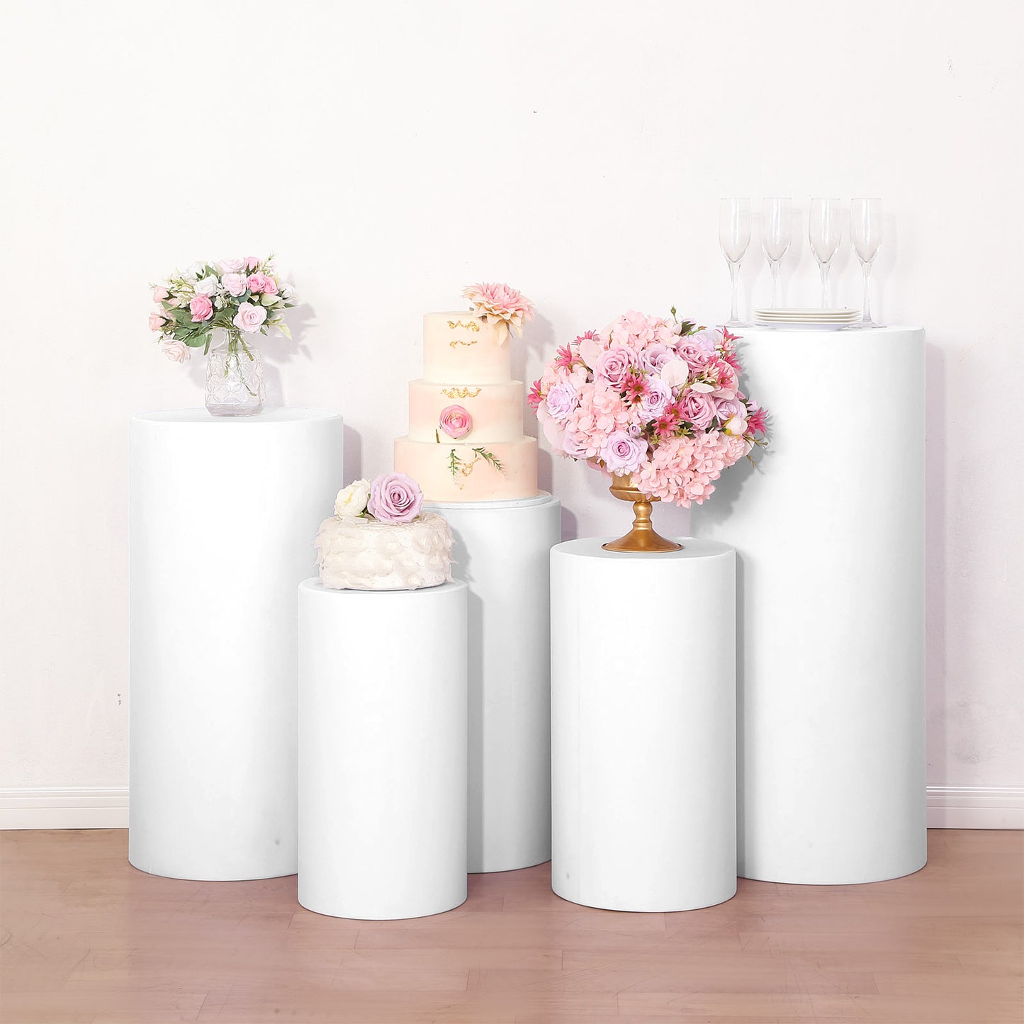 White spandex cylinder pedestal stand covers for events and displays.