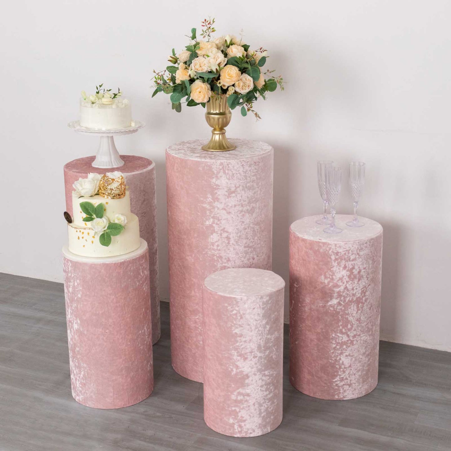 Blush crushed velvet pedestal stand covers for elegant displays.
