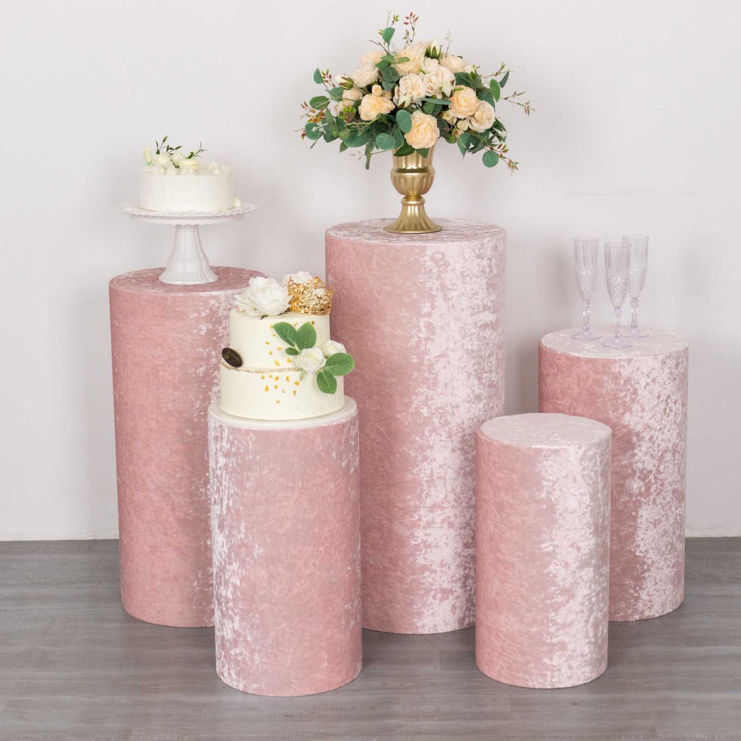 Blush crushed velvet pedestal stand covers for elegant displays.