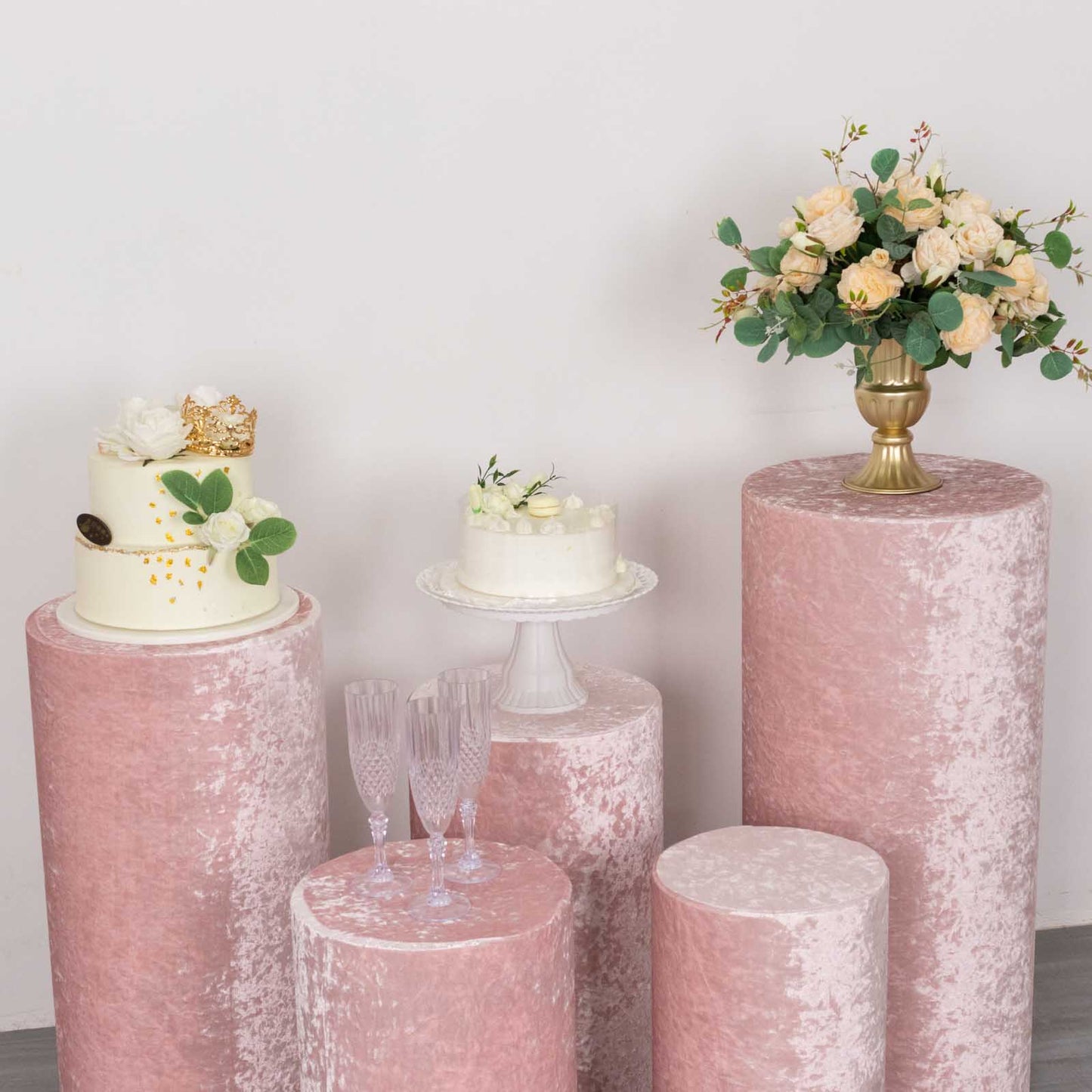 Blush crushed velvet pedestal stand covers for elegant displays.