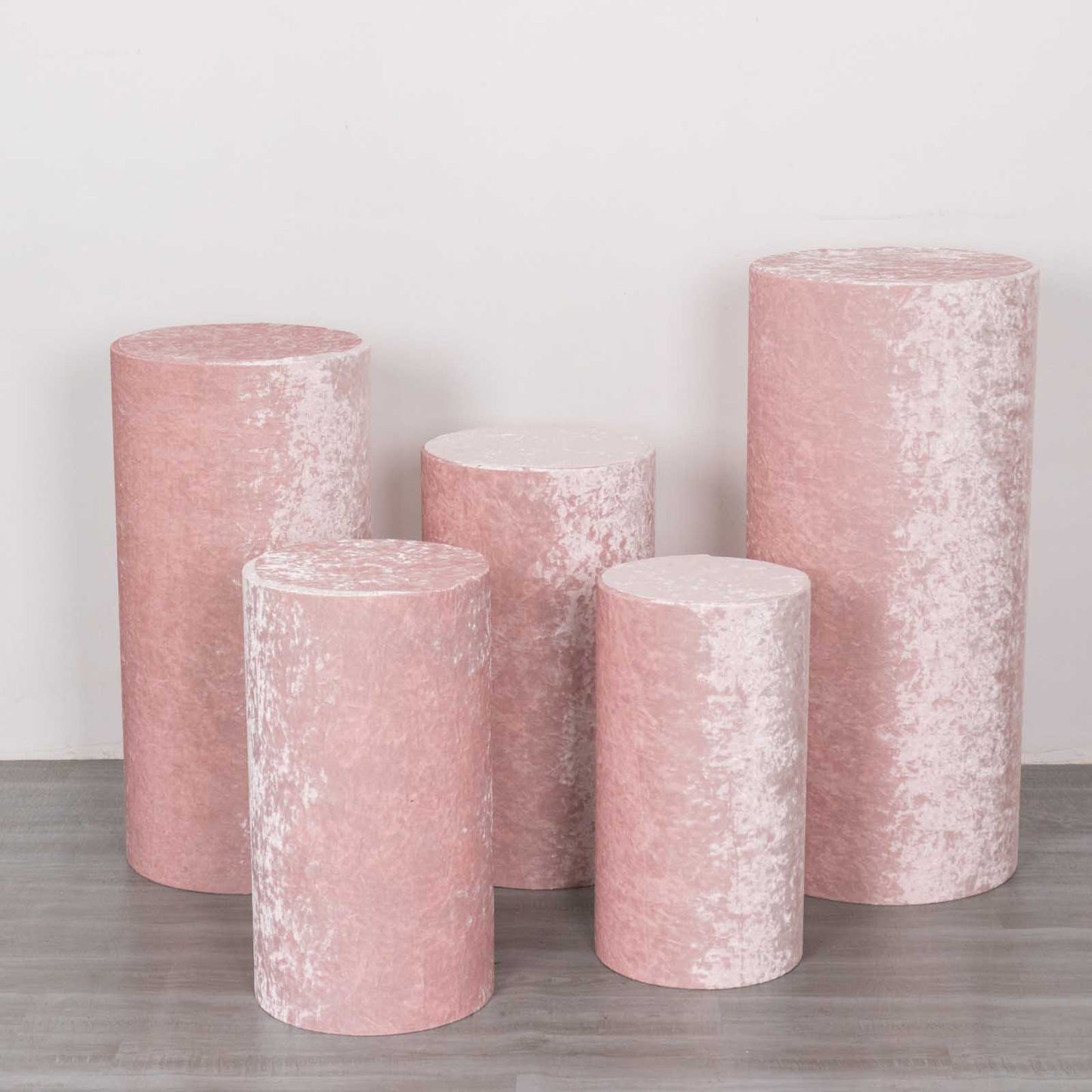 Blush crushed velvet cylinder pedestal stand covers in a set of 5.