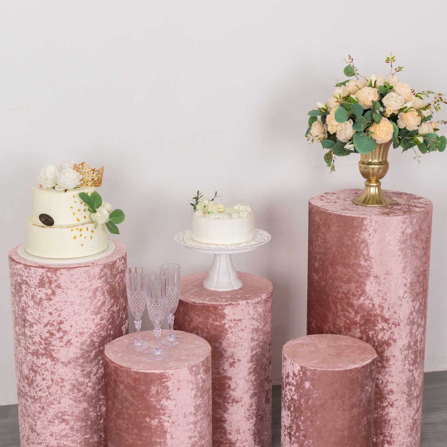 Dusty rose crushed velvet pedestal stand covers for events and displays.