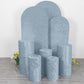 Dusty blue crushed velvet pedestal stand covers set on a floral backdrop.