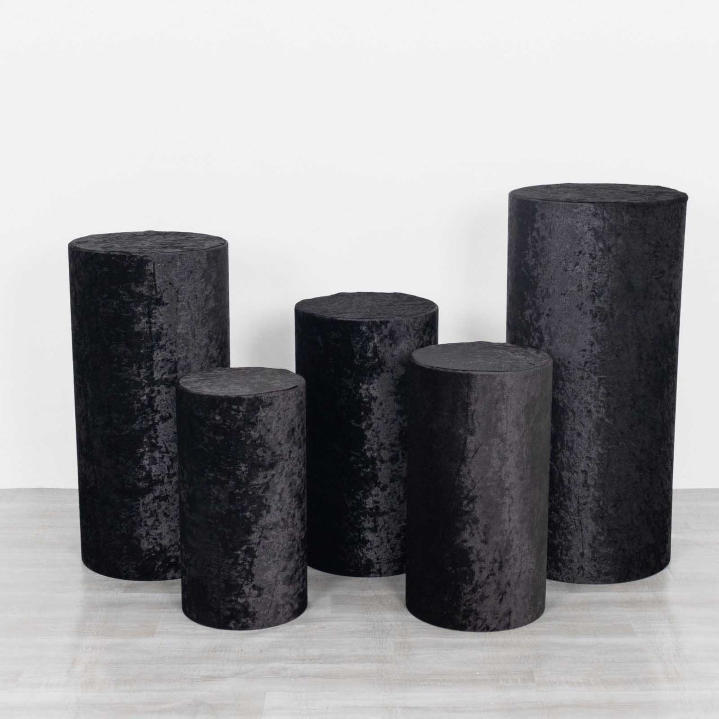 Set of 5 black crushed velvet pedestal stand covers.