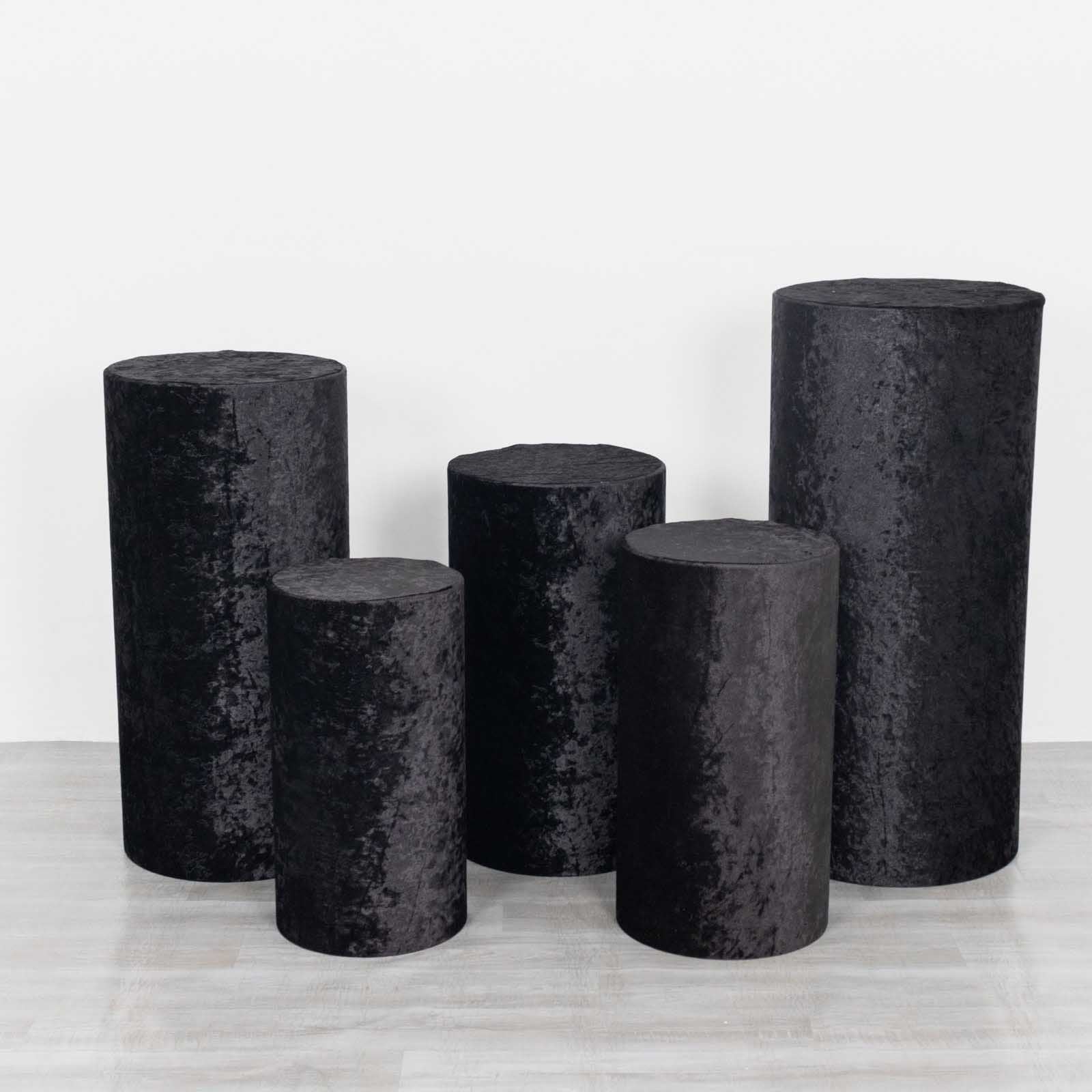 Set of 5 black crushed velvet pedestal stand covers.