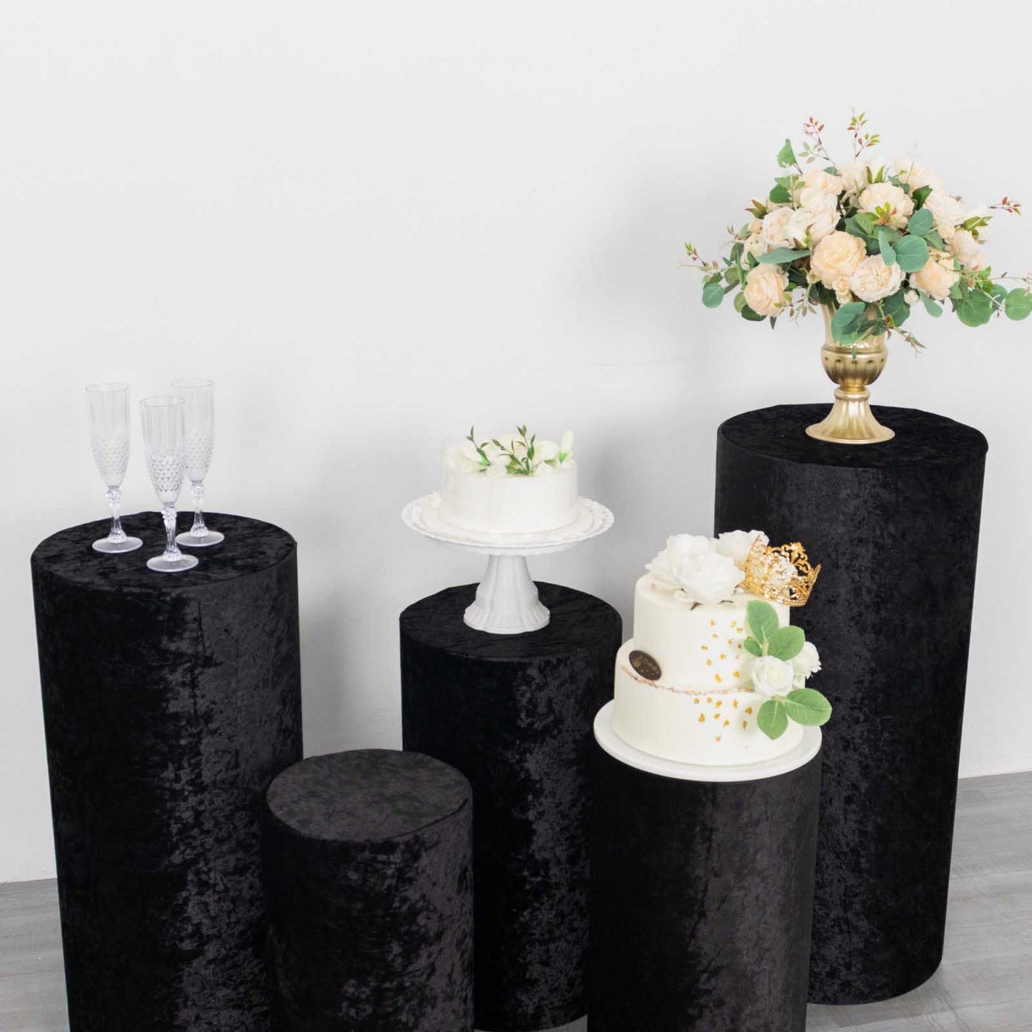 Black crushed velvet pedestal stand covers for elegant displays.
