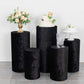 Set of 5 black crushed velvet pedestal stand covers for events.