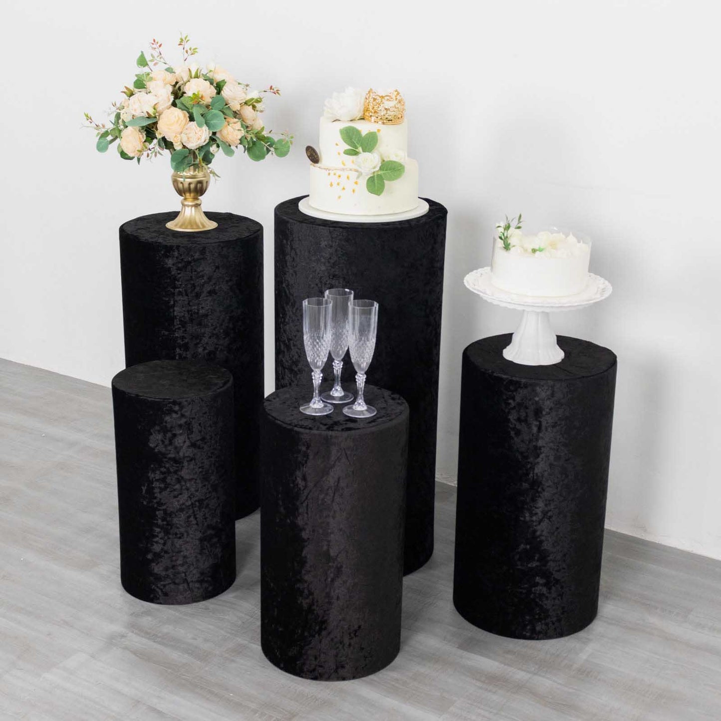 Black crushed velvet pedestal stand covers for elegant displays.