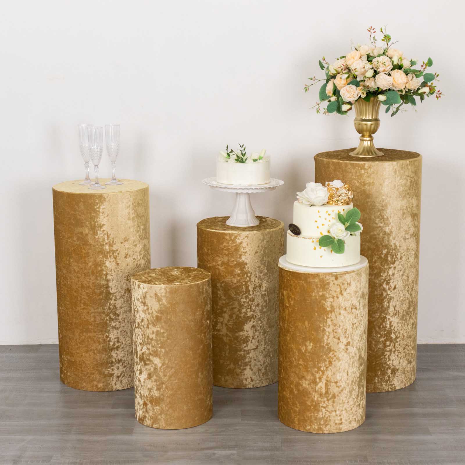 Champagne crushed velvet pedestal stand covers for elegant displays.