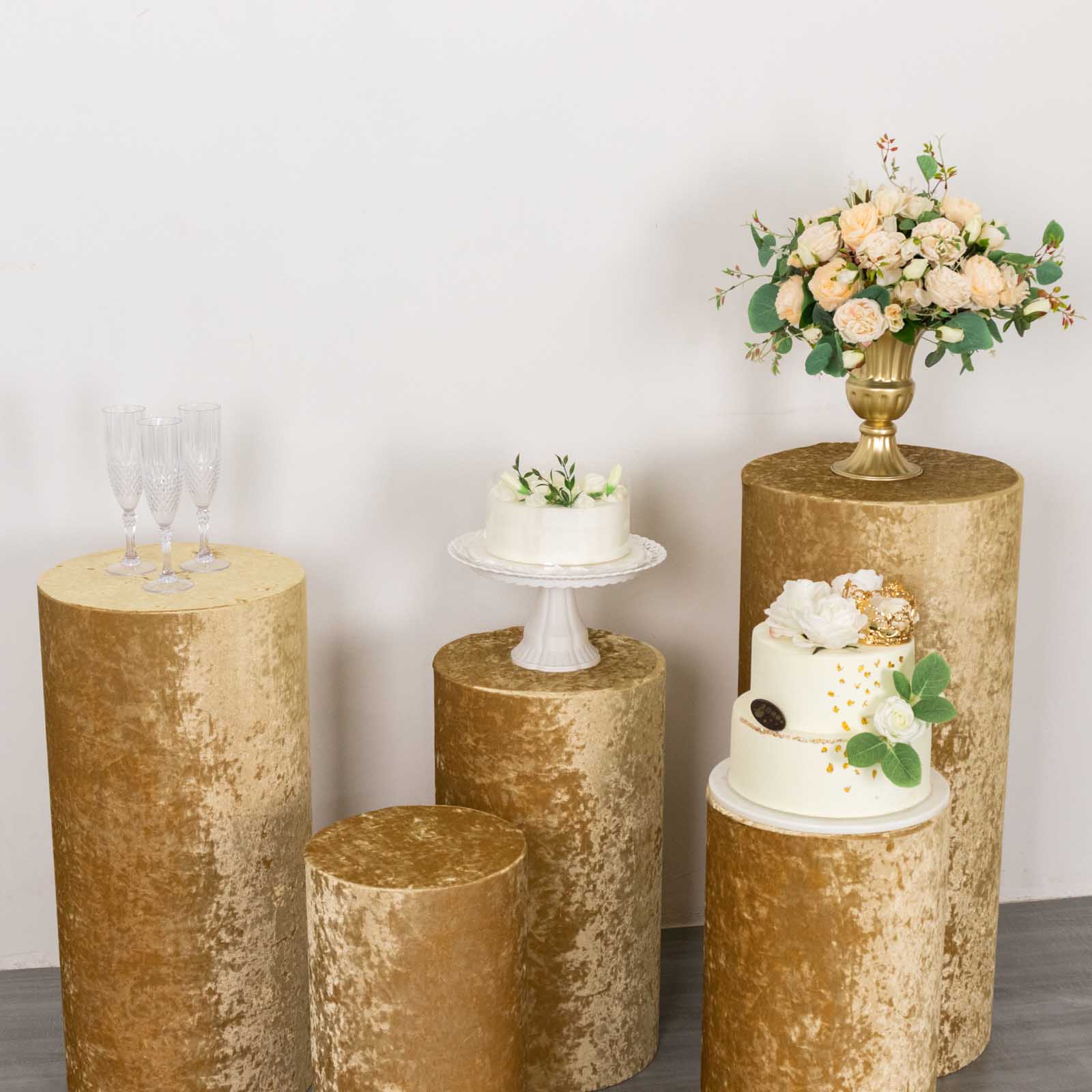 Champagne velvet pedestal stand covers for events and displays.