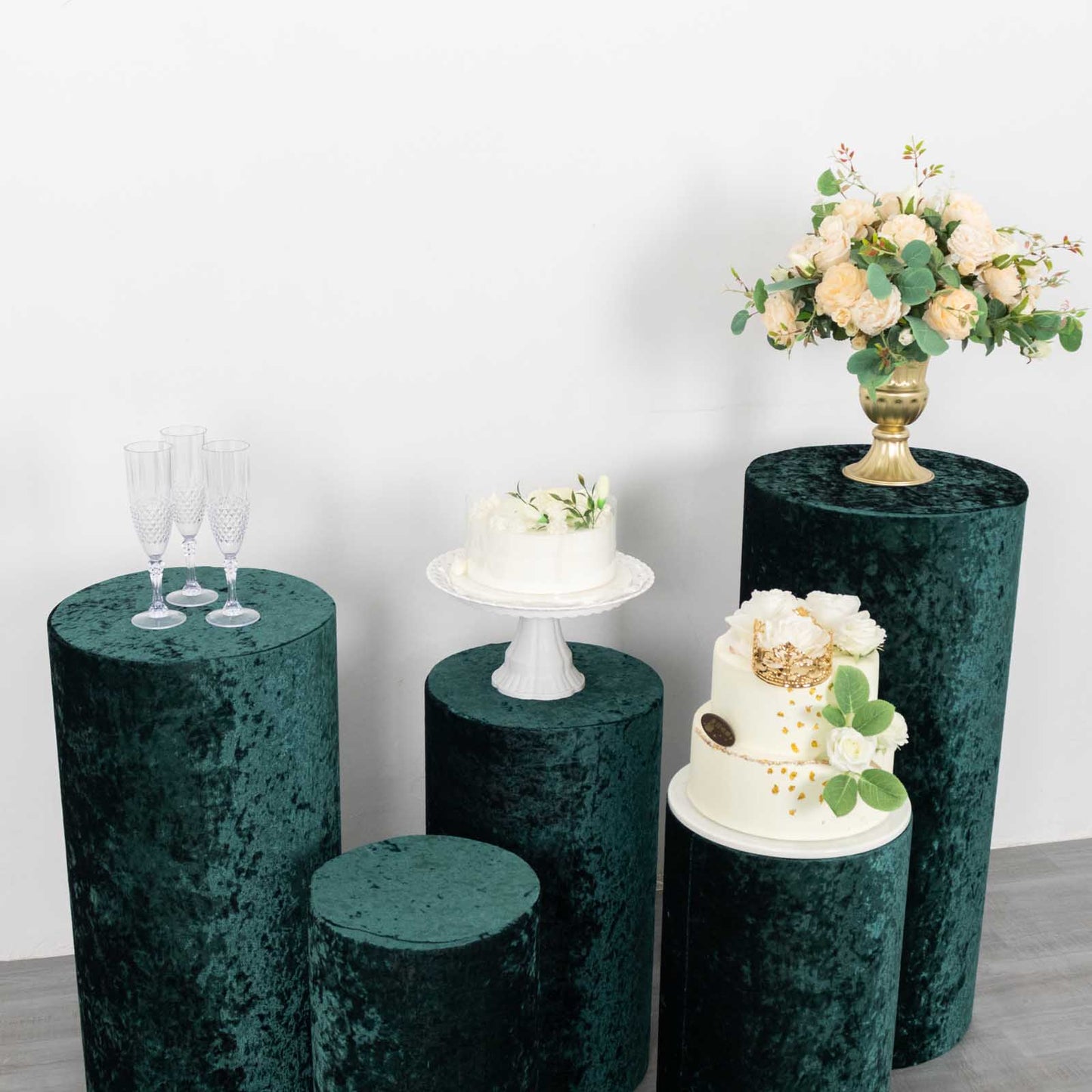Emerald green crushed velvet pedestal stand covers for elegant displays.