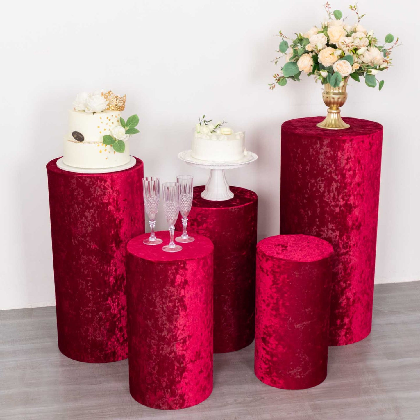 Set of 5 red crushed velvet pedestal stand covers for events and decorations.