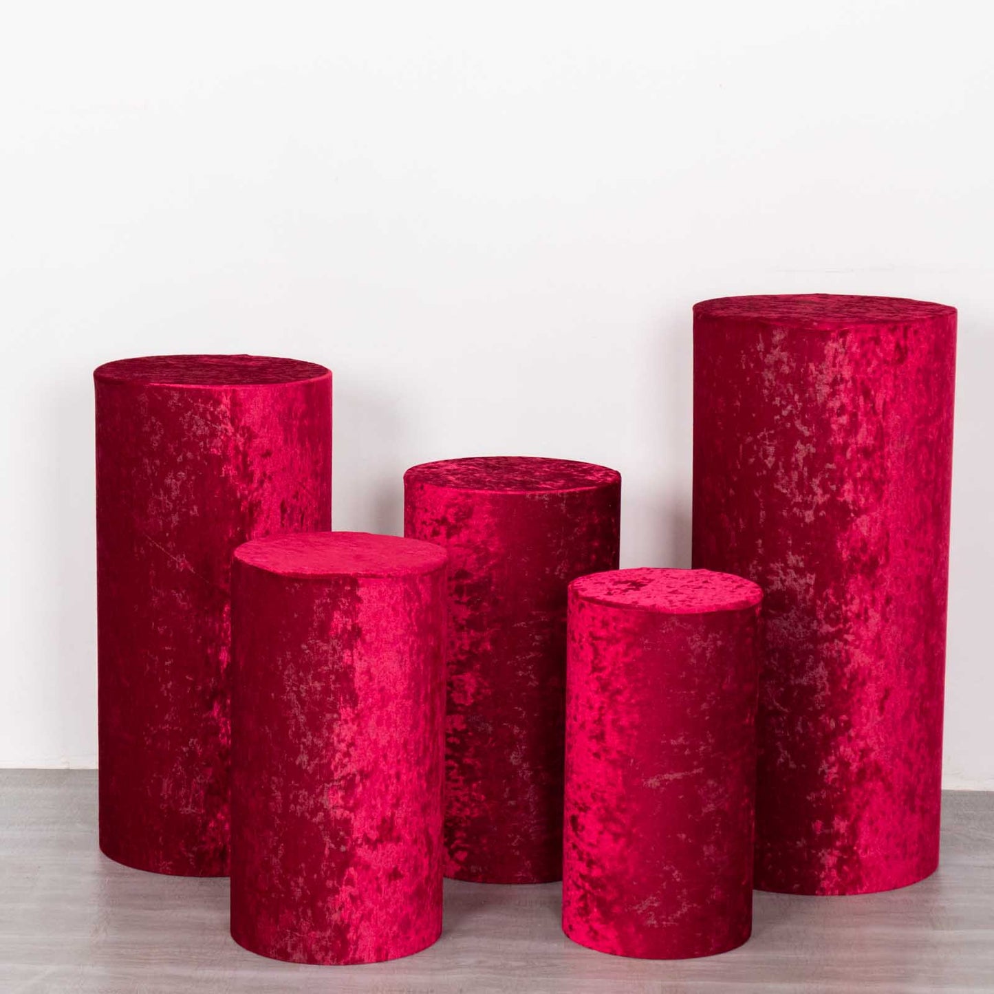 Set of 5 red crushed velvet pedestal stand covers.