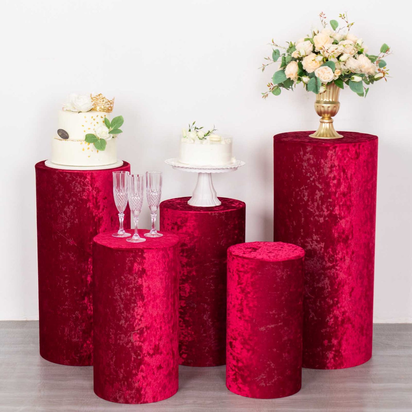 Red crushed velvet pedestal stand covers set for elegant displays.