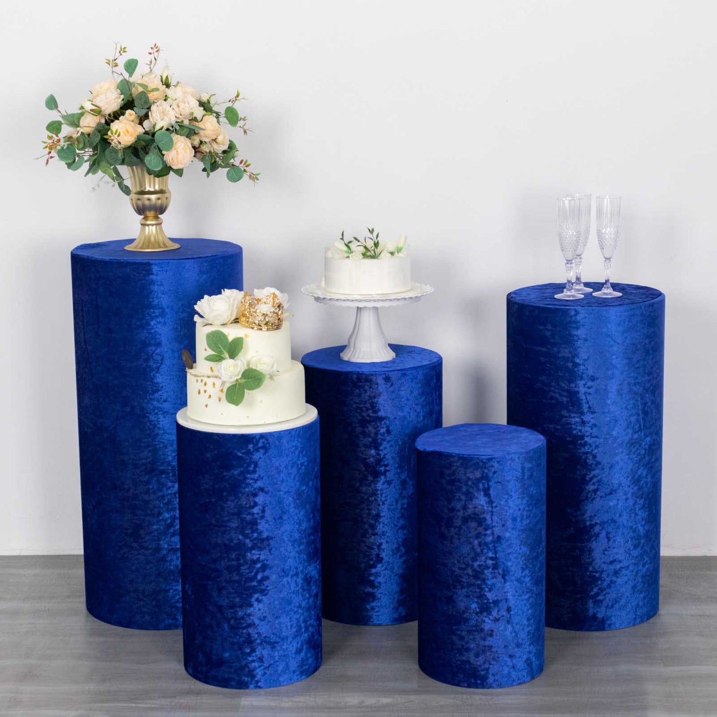 Royal blue crushed velvet pedestal stand covers for decorative displays.