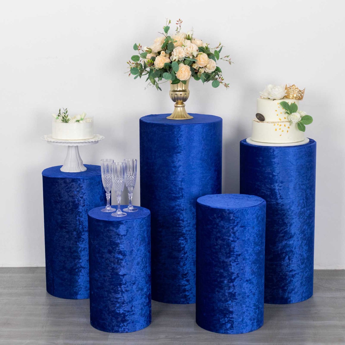 Royal blue crushed velvet pedestal stand covers for elegant decor.
