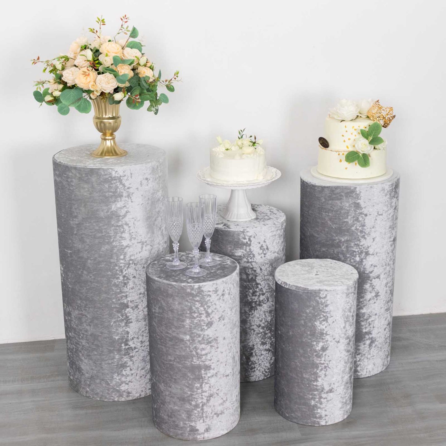 Set of 5 silver crushed velvet pedestal stand covers for events.