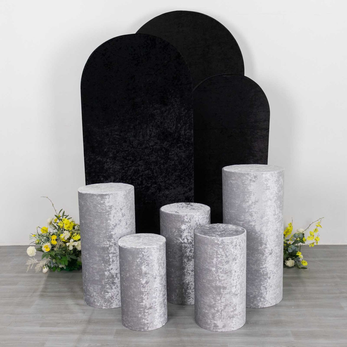 Silver crushed velvet pedestal stand covers for event decoration.