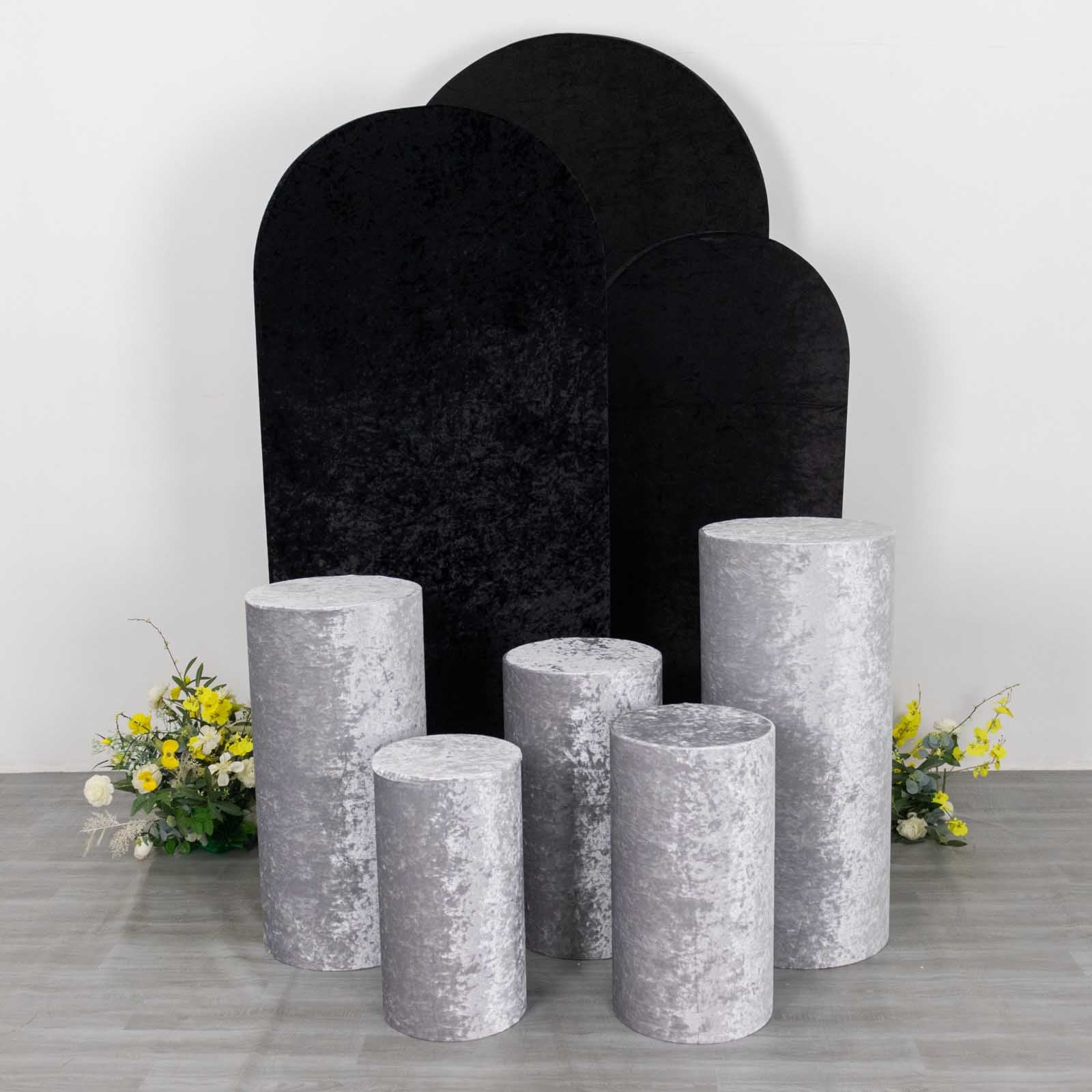 Silver crushed velvet pedestal stand covers for event decoration.