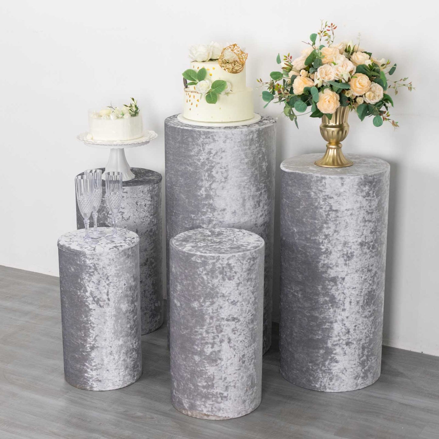 Silver crushed velvet pedestal stand covers for decorative displays.