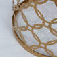 Gold metal cylinder pillar cake display stand with hollow overlapping circles pattern.