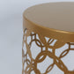 Gold metal cylinder cake display stand with hollow overlapping circles pattern.