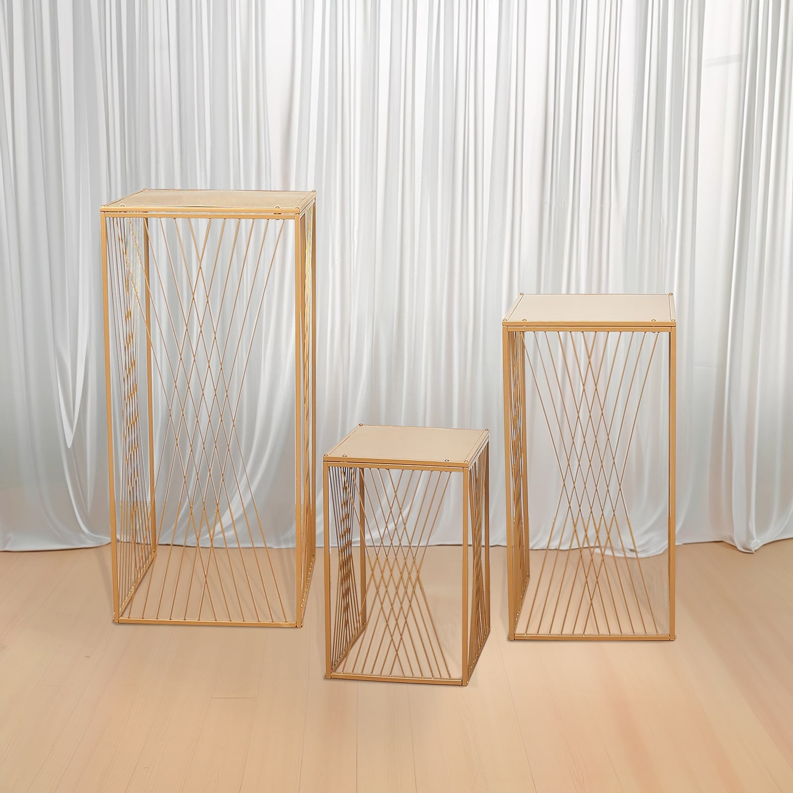 Gold metal rectangular plant stands with geometric crossed lines pattern.