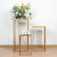 Gold metal rectangular plant stands with geometric pattern, floral displays.