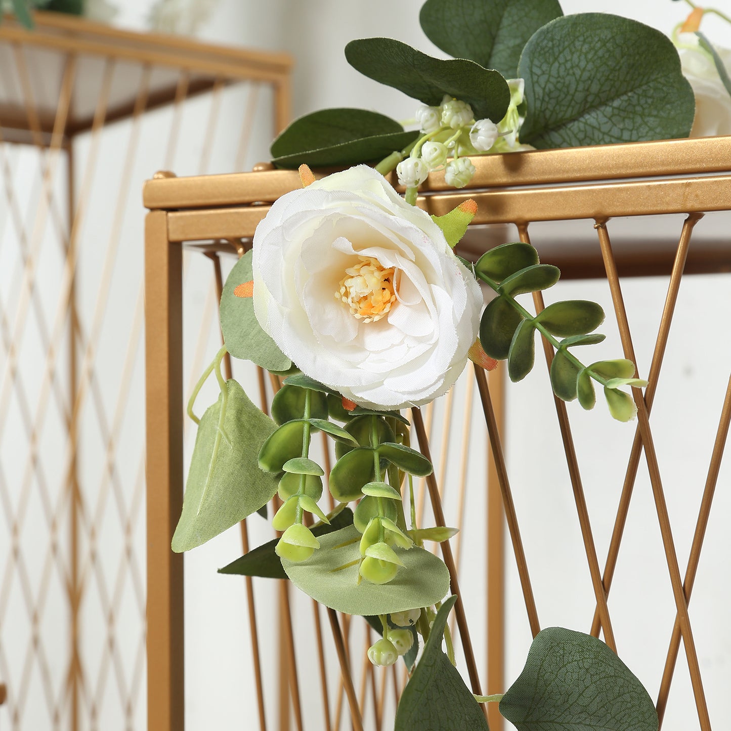 Gold geometric plant stands with floral decor, perfect for cake or floral displays.
