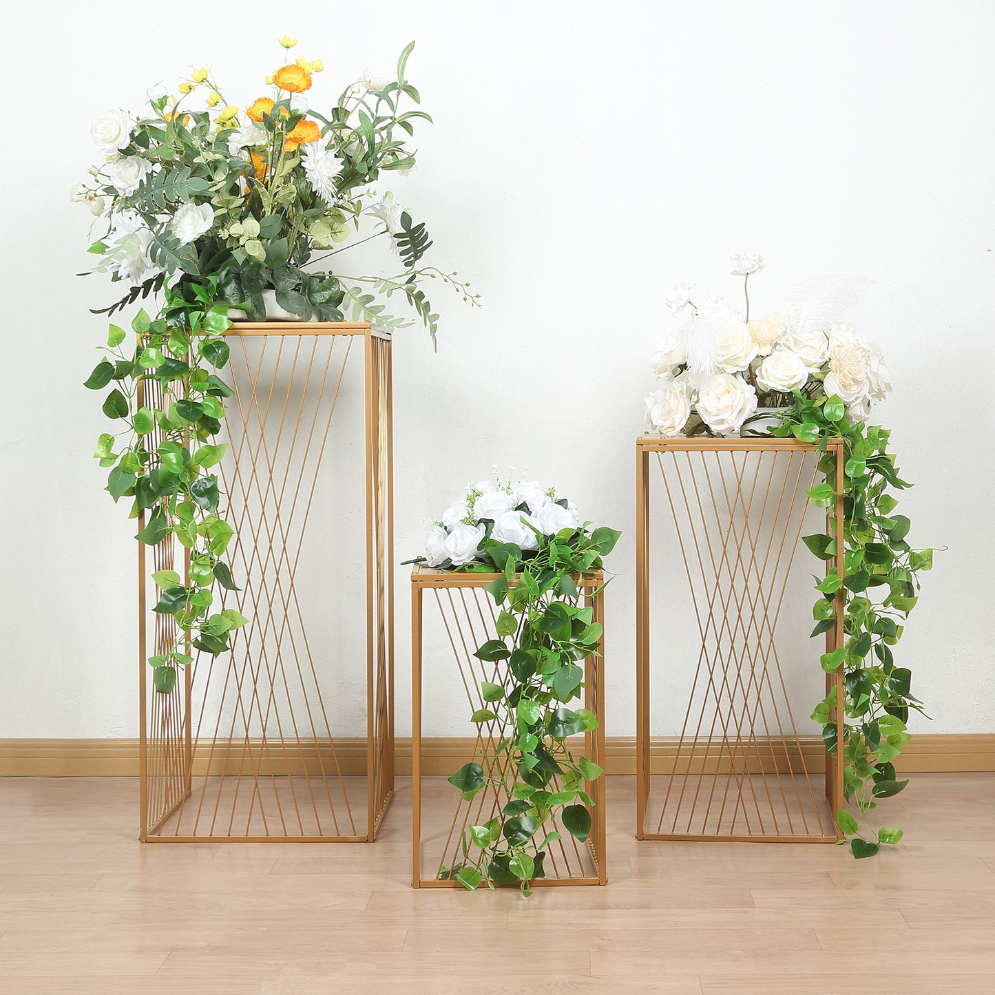 Gold metal rectangular plant stands with geometric design, perfect for floral displays.