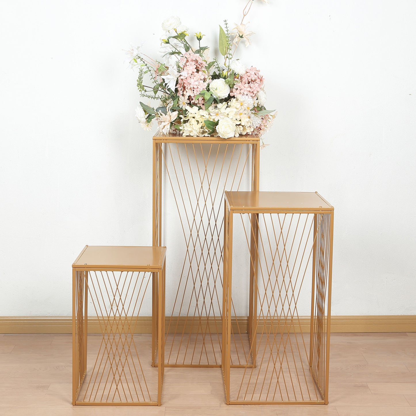 Gold metal rectangular plant stands with geometric design, perfect for floral displays.