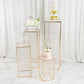 Gold metal pedestal stands set with acrylic tops and crystal pendants.