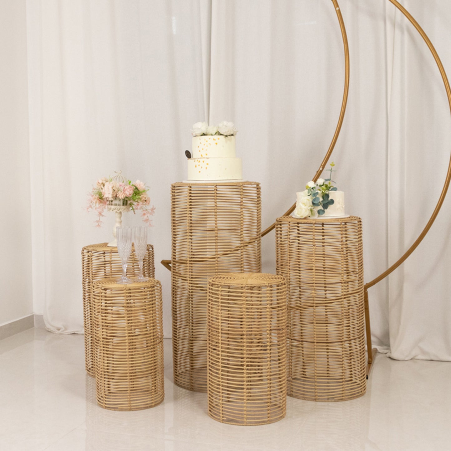 Natural woven rattan wicker pedestal stands in various heights for decor display.