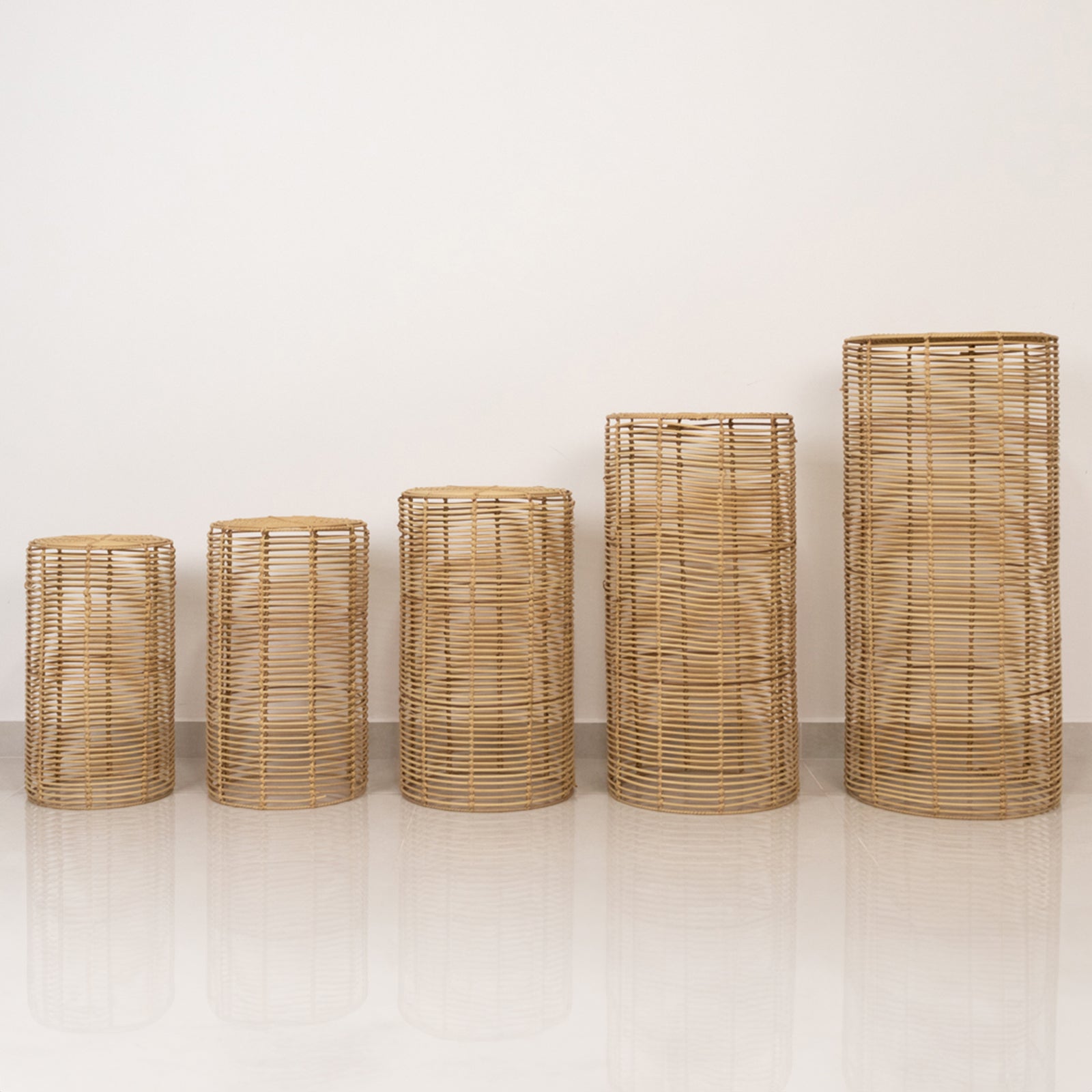 Natural woven rattan wicker pedestal stands in various heights.